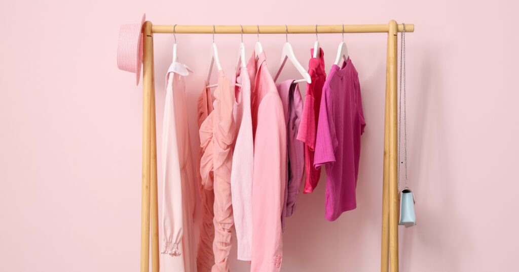 rack of red, white, and pink clothing showing caring for red clothing with proper fabric care and gentle laundry practices
