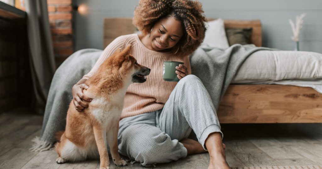 Pet owner using pet owner laundry tips to remove fur and odor from clothes at a laundromat.