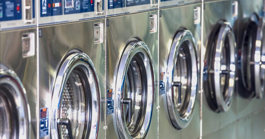 rows of large capacity washers showing how efficient laundromats save time and money